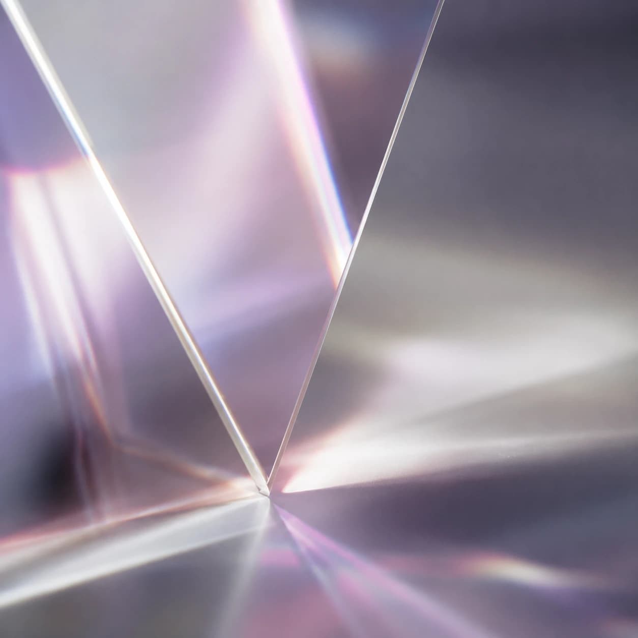 Prism refracting lavender light — editorial still life.