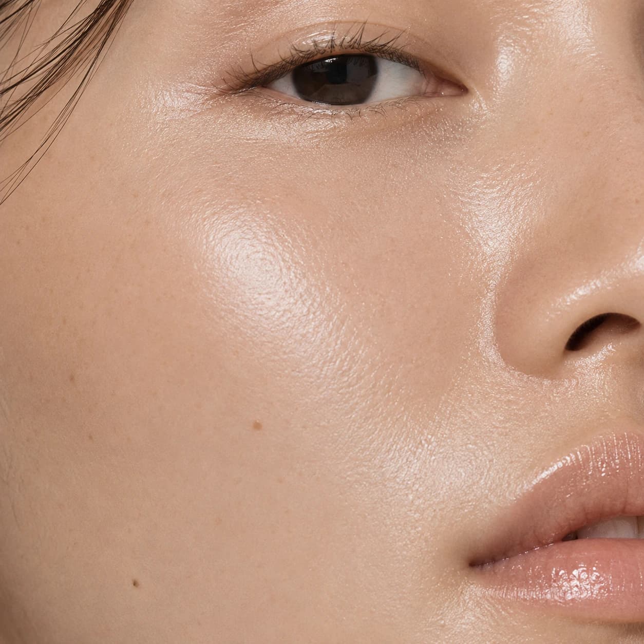 Editorial crop of even, luminous skin tone.